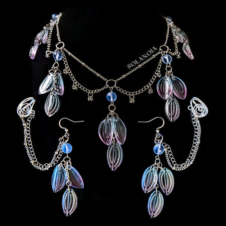 Fairy of Shampoo txt kpop necklace earrings set, black background. Choker has five dangling transparent pink blue gradient leaves in groups of three. Blue opalescent/iridescent mermaid glass beads connected by stainless steel chains, sparkling clear accent